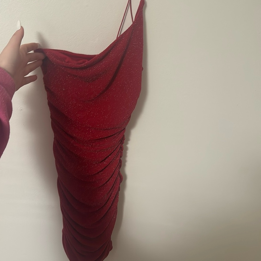 A red sparkly sequin dress that is cinched